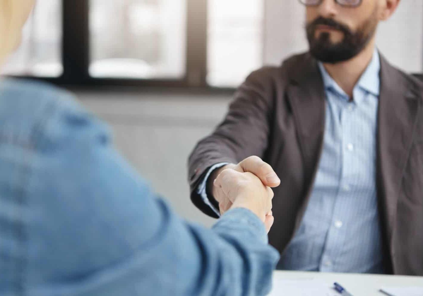 successful-businesspeople-shake-hands-after-signed-contract_273609-5123